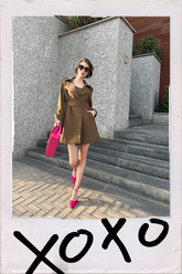 a lady in camel trench coat with hot pink high heels